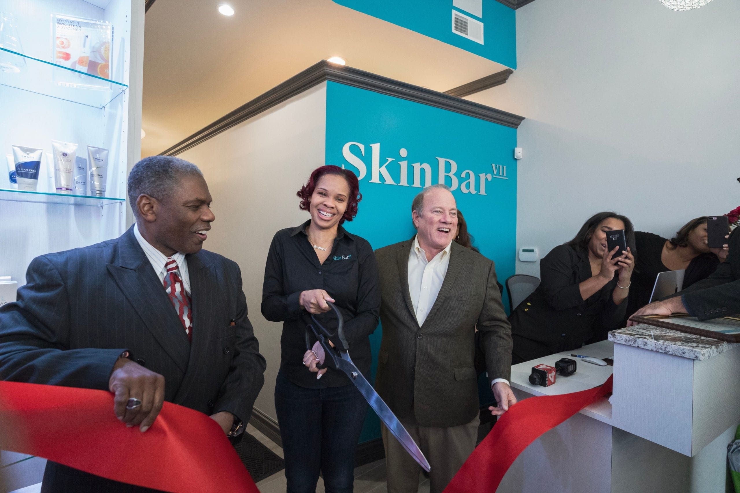 Sevyn Jones cuts ribbon at the grand opening ceremony for Skin Bar VII
